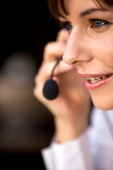 Image of a female employee answering the telephone.